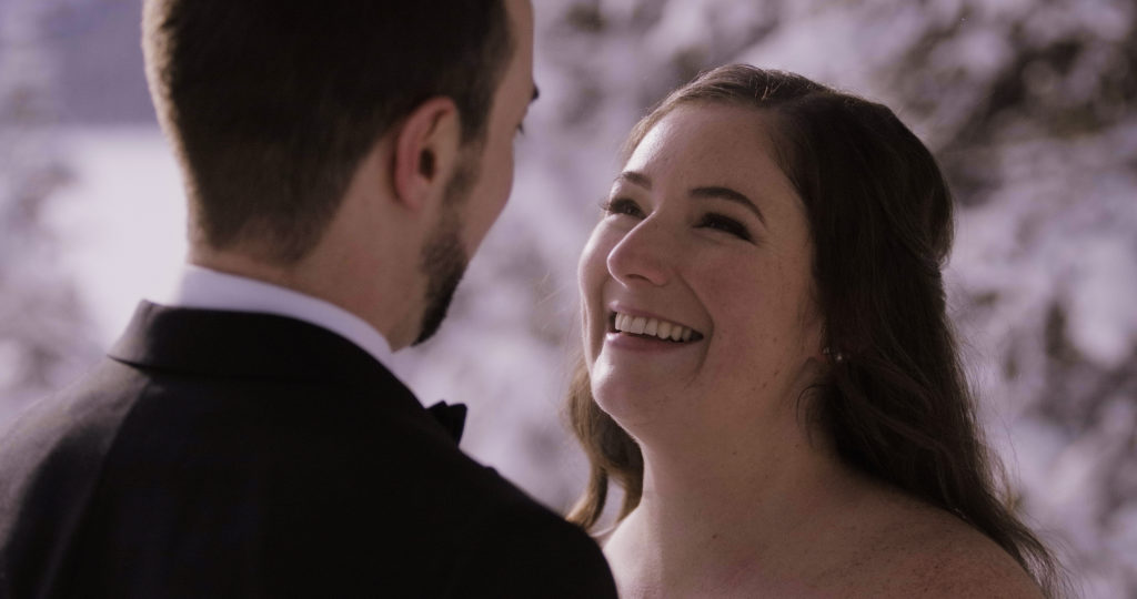 intimate moment in lake louise during an elopement in winter
