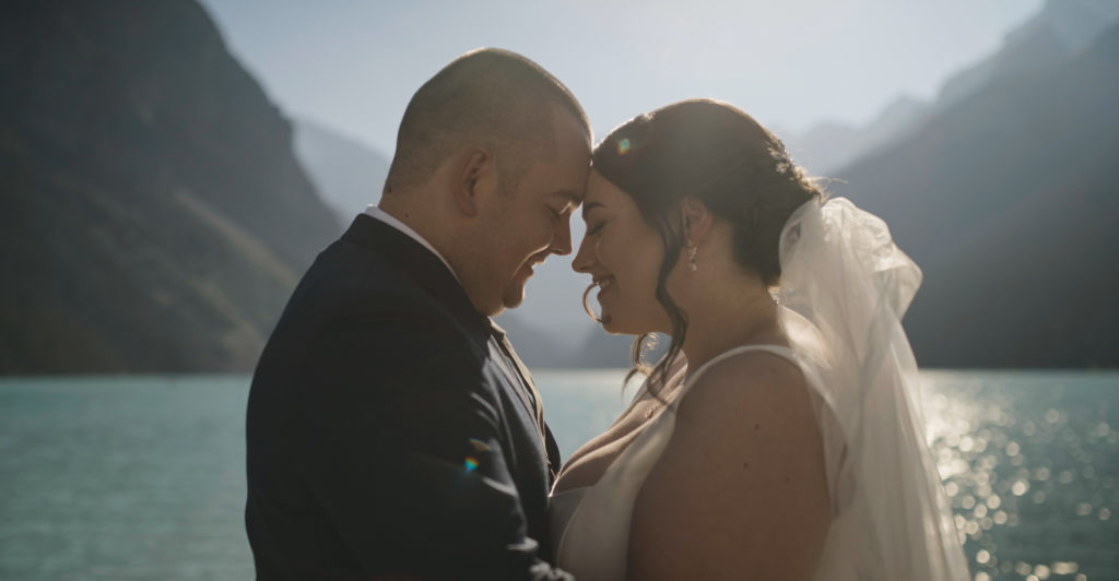 Initimate moment during elopement at lake louise in banff national park