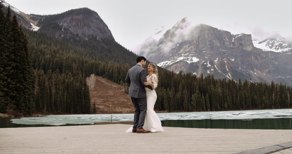 Couple sharing their first dance on the shores of Emerald lake